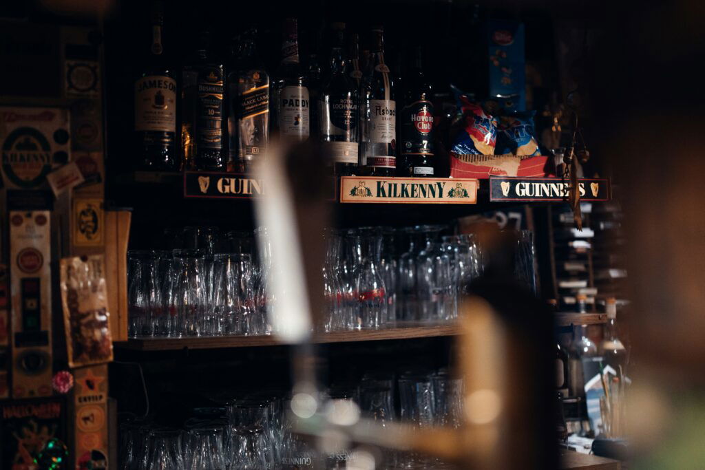 The back of an Irish bar including a sign for Guiness marketing