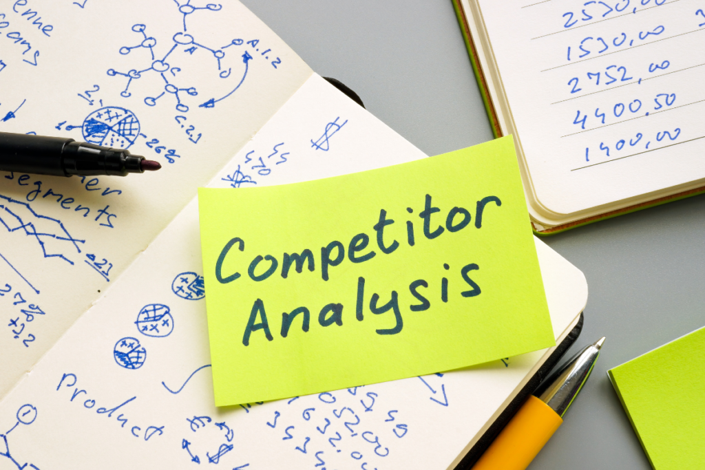 A post-it note with 'competitor analysis' written on it symbolising the competitor analysis services offered by Chameleon