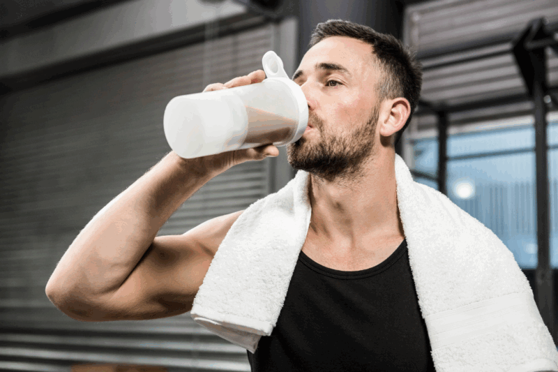 A man drinking a Huel protein shake promoted by Huel's marketing campaigns and strategies